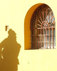 Silhouette man by building against sky