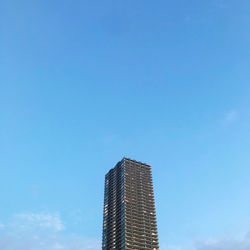 Low angle view of modern buildings against clear blue sky