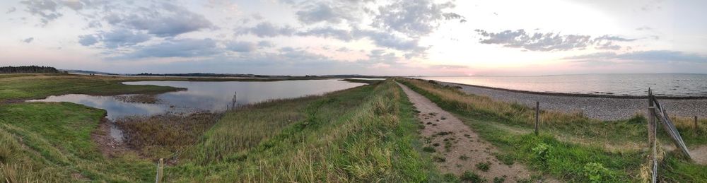 Panoramic shot of sea against sky during sunset