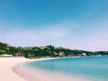 Scenic view of beach against blue sky