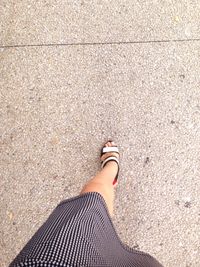 Low section of woman standing on tiled floor