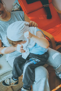 Girl sitting with mother at home