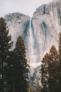 Scenic view of waterfall against sky