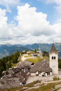 Houses against cloudy sky