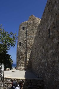 Low angle view of old building against blue sky