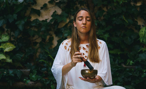 Full length of a young woman holding food