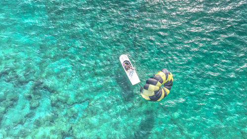 High angle view of people swimming in sea