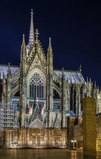 Illuminated building against sky at night