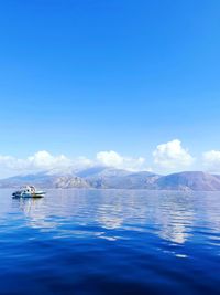 Scenic view of sea against blue sky