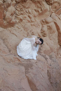 Young woman with a wedding dress in the nature
