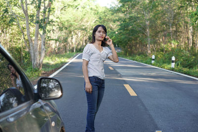 Full length of woman standing on road