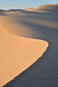 Scenic view of desert against sky during sunset