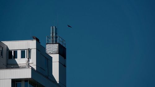 Low angle view of building against clear blue sky