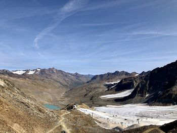 Scenic view of mountains against blue sky