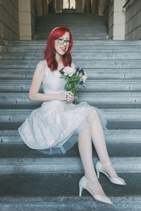 Young woman sitting on steps