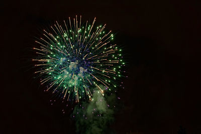 Low angle view of firework display at night