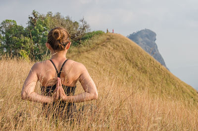 Woman standing on grassy field