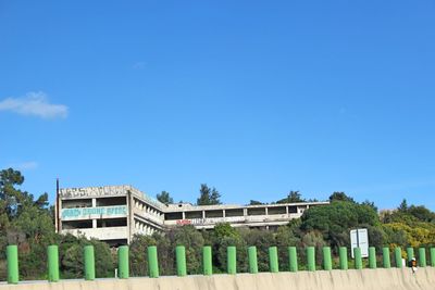 Low angle view of buildings against clear blue sky