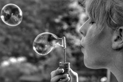 Close-up of boy blowing bubbles