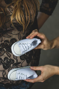 Low section of woman holding hands