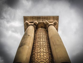 Low angle view of building against cloudy sky