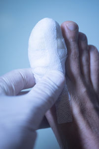 Close-up of person holding hands over white background