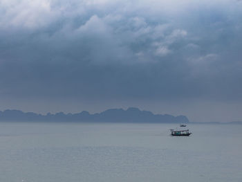 Boat sailing in sea against sky