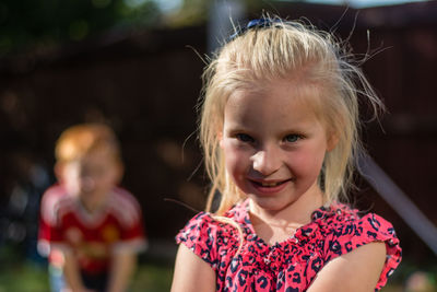 Close-up portrait of girl smiling outdoors