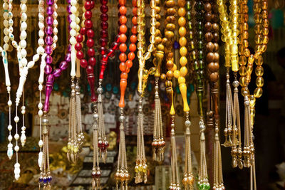 Close-up of prayer beads hanging in row