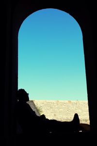 Silhouette of man against blue sky