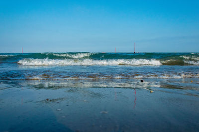 Scenic view of sea against clear blue sky