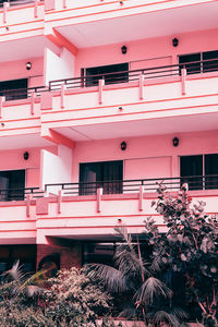 Low angle view of pink and building in city