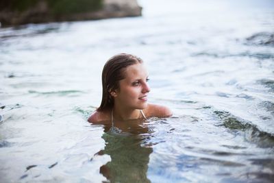 Portrait of young woman in water