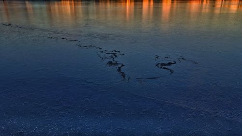 Scenic view of lake at sunset