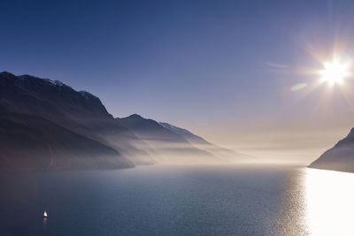 Scenic view of sea and mountains against sky