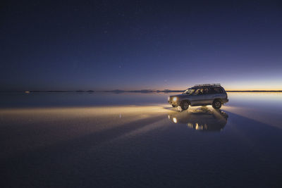 Car over the water under the stars