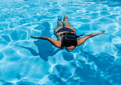 Young woman in bikini in swimming pool. summer, lifestyle.