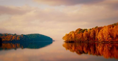 Scenic view of lake against sky during sunset