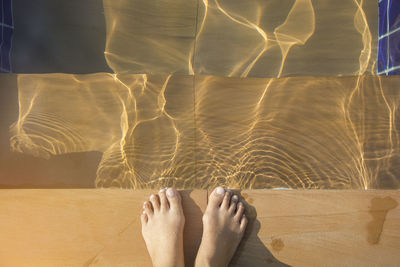 Low section of woman standing in water