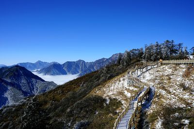 Scenic view of mountains against clear blue sky