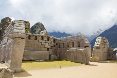 Ruins of building against cloudy sky