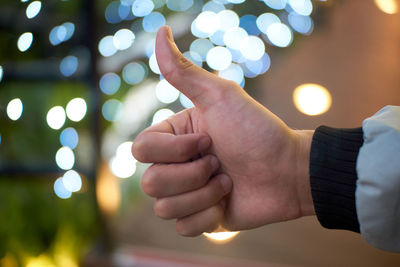 Close-up of hand holding illuminated lights