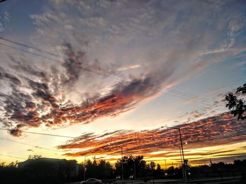 Low angle view of silhouette trees against sky during sunset