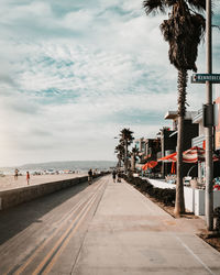 Road by sea against sky in city