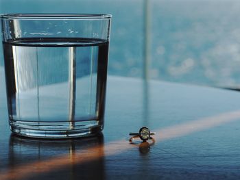 Close-up of drinking water by ring on table