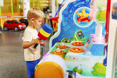 Portrait of boy playing with toys