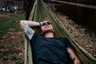 Happy man relaxing in hammock