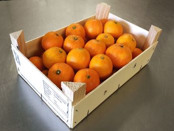 Close-up of oranges in crate
