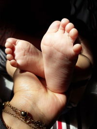 Close-up of hands holding baby hand