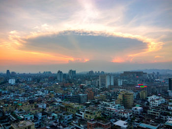 Aerial view of cityscape against sky during sunset